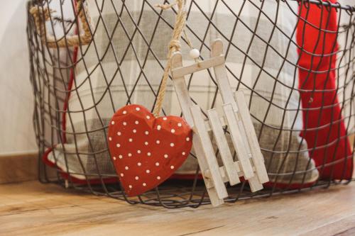 a red heart ornament hanging from a basket at Apartments and Rooms Kaja in Kranjska Gora