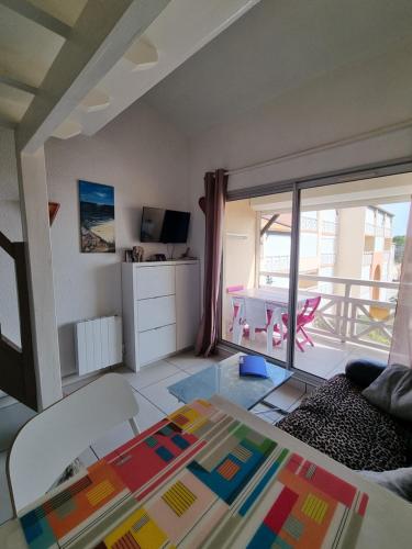 a living room with a view of a balcony at Les hauts d'azur in Saint Pierre La Mer