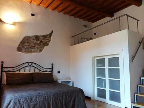 een slaapkamer met een bed en een stenen muur bij Seashell Piombino in Piombino