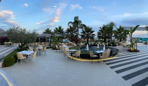 a patio area with tables, chairs and umbrellas at Sole Luna Hotel in Borsh
