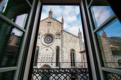 a view of a church from a window at Aurum - Como Luxury Suites in Como