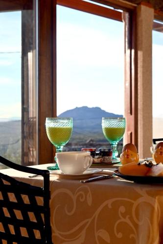 a table with two wine glasses on top of it at Casal da Serra in Penha Garcia