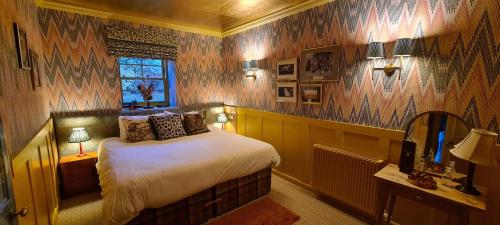 a bedroom with a bed in a room with wooden walls at The Glenmorangie House in Tain