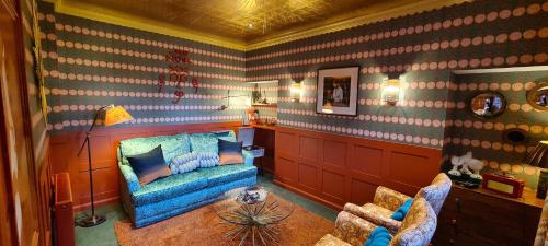 a living room with a blue couch and a table at The Glenmorangie House in Tain