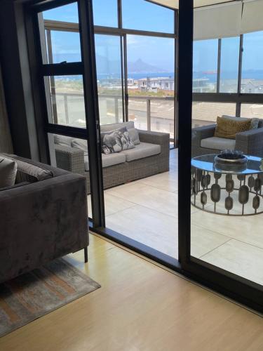 a living room with a couch and a table at Waves Edge CP3 in Cape Town