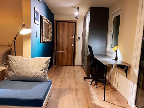 a room with a desk and a couch and a table at Athens Skylight Condo in Athens