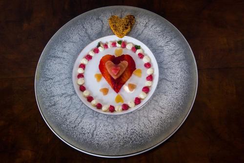 a plate with a heart shaped cake on a table at Crug Glas Country House in St. Davids