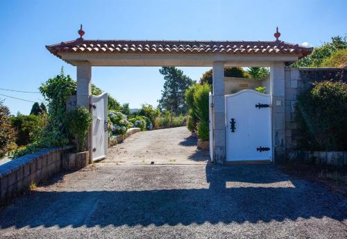 an entrance to a house with a white door at Casa Vieje de Bueu in Bueu