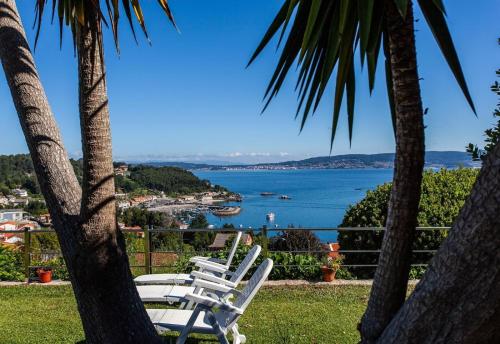 a group of chairs sitting on top of a beach at Casa Vieje de Bueu in Bueu