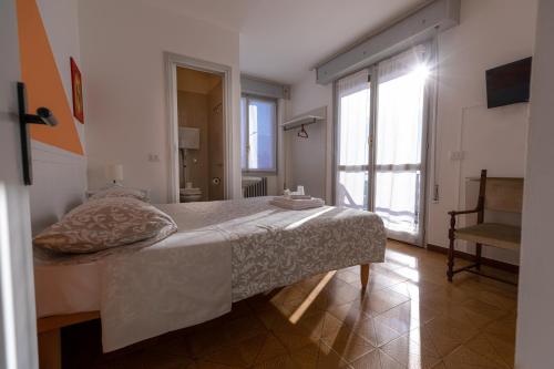 a bedroom with a bed and a large window at La Svolta in Chiuro