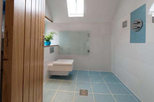 a bathroom with a toilet and a sink in it at Meddlars a historic cottage on the countryside edge of a vibrant Market Town in Hadleigh