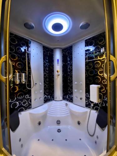 a bath tub in a room with a ceiling at Aral Hotel Apartments in Tabuk