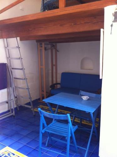 a blue table and a blue chair in a room at Il Cubo, monovano col mare su tre fronti. in Favignana