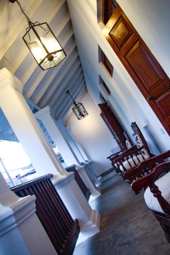 a staircase in a house with a light fixture at Zee Golf Affordable Luxury in Galle