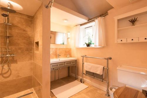 a bathroom with a shower and a sink at Rose Cottage rural cosiness with footpaths to the local Macro Brewery Pub 