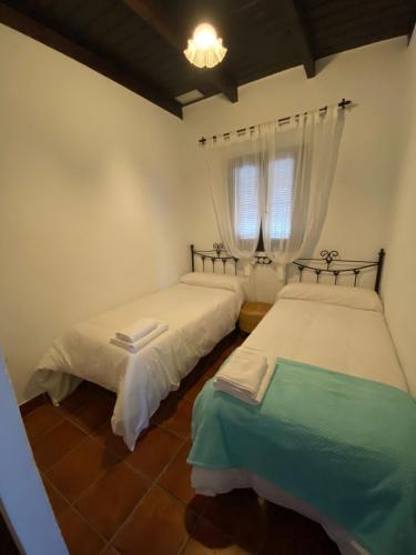 Ένα ή περισσότερα κρεβάτια σε δωμάτιο στο CASA KIKA ROCIO