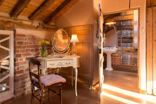 a bathroom with a white desk and a sink at Dons Barn a Stunning cottage just a walk across the fields to a great pub 