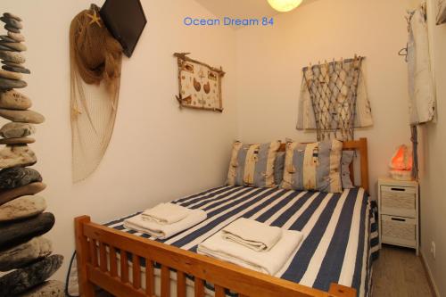 a bedroom with a bed with blue and white stripes at Ocean Dream 84 - Apt. T1 na Praia de São Rafael, Albufeira in Albufeira