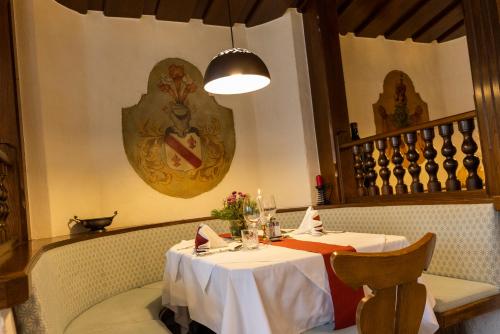 a dining room with a table and a light fixture at Alpenhotel Ensmann in Göstling an der Ybbs