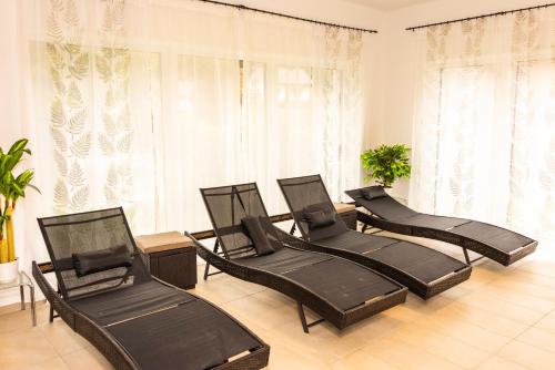 four black chairs in a room with windows at Alpenhotel Ensmann in Göstling an der Ybbs