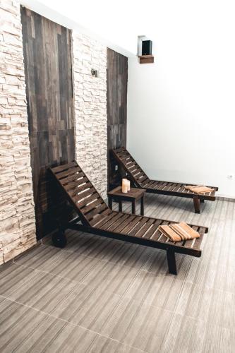 a room with two wooden benches and a brick wall at Verdisso Hotel & Restaurant in Demir Kapija
