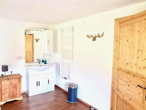 a bathroom with a sink and a mirror at Landhaus Wiesle in Tannheim