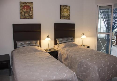 two beds sitting next to each other in a bedroom at Stunning Villa near Velez-malaga in Arenas