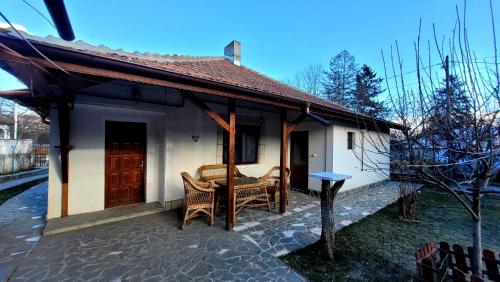 a small white house with a table and chairs at Casa Mara in Breaza