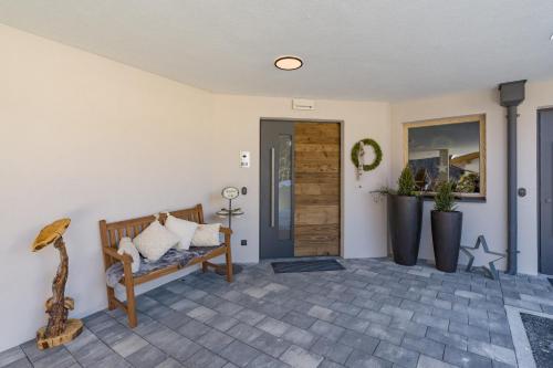a living room with a bench and a door at Isskogel Suites in Gerlos