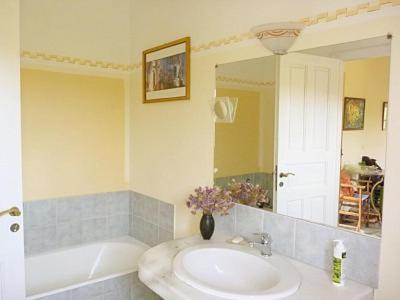 a bathroom with a sink and a mirror and a tub at Katzilieris Country House in Naxos Chora