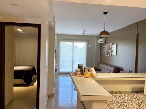 a room with a kitchen and a living room at 9 de Julio Park Suites in San Miguel de Tucumán