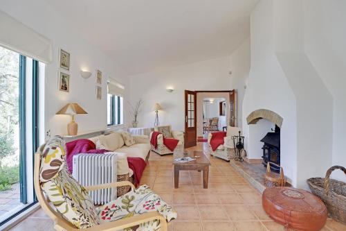 a living room with a couch and a fireplace at Algarve Country Villa 1 With Pool by Homing in Santa Bárbara de Nexe