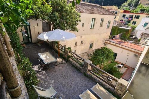 an overhead view of a patio with an umbrella and chairs at Loft Apartments by AMALFIVACATION in Amalfi