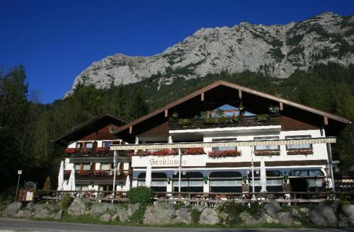 a large building with a mountain in the background at Gasthaus-Pension Seeklause in Ramsau