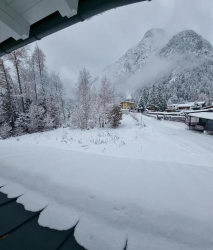 a snow covered field with a mountain in the background at Mountain Pearl in Maurach