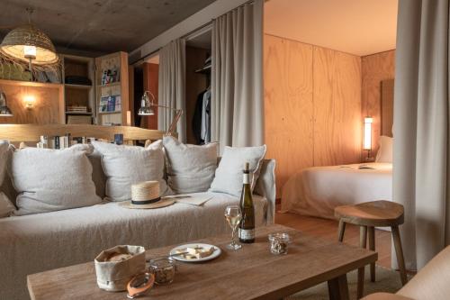 a living room with a couch and a bed at MOB House in Saint-Ouen