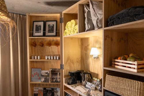 a kitchen with wooden shelves with food on them at MOB House in Saint-Ouen
