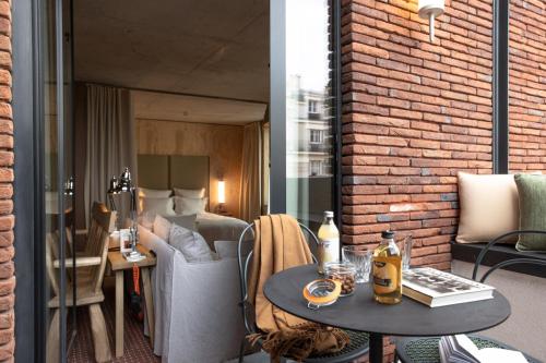 a hotel room with a bed and a table with a table at MOB House in Saint-Ouen