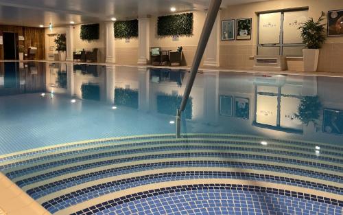 a large swimming pool with a large mirror at The Montenotte Hotel in Cork