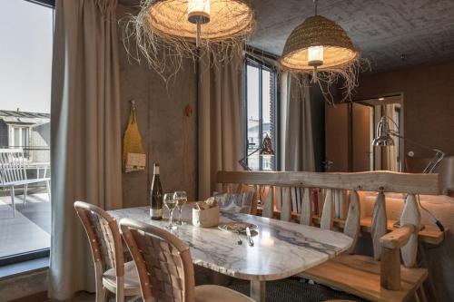 a dining room with a wooden table and chairs at MOB House in Saint-Ouen