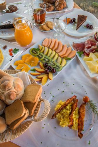 a table with plates of food on a table at Tiliguerta Glamping&Camping Village in Costa Rei