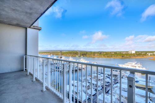a balcony with a view of a marina at Two-Bedroom Apartment in Orange Beach
