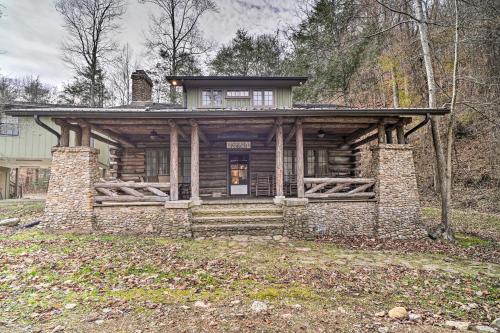 a log home with a porch on a field at Tranquil Smoky Mountain Cabin with Porch and Fire Pit in Newport
