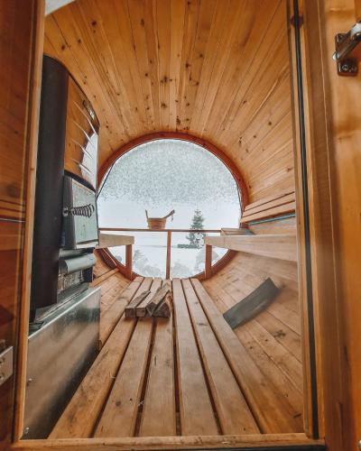 a view from the inside of a wooden room with a stove at Costa del Kryspi Całoroczne Domy na Wodzie in Cholerzyn
