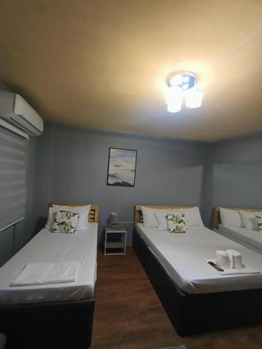a room with two beds in a room at Djci Apartelle with kitchen n bath 211-209 in Cabanatuan