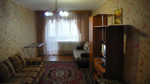 トムスクにあるKvartiraのリビングルーム(ソファ、テレビ付)