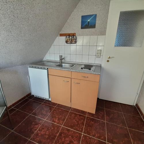 a small kitchen with a sink and a stove at Ferienwohnung Greschke in Prerow
