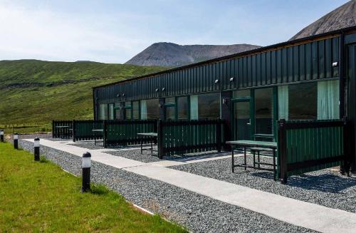 a row of benches in front of a building at Kinloch Ainort Apartments in Luib