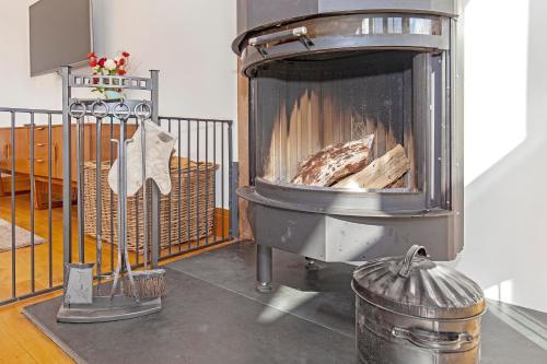 a stove with a fire in a room at Amber Lodge in Ashover