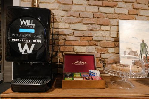 a wooden table with a black wii on a brick wall at B&B Civico 35 in Chieti
